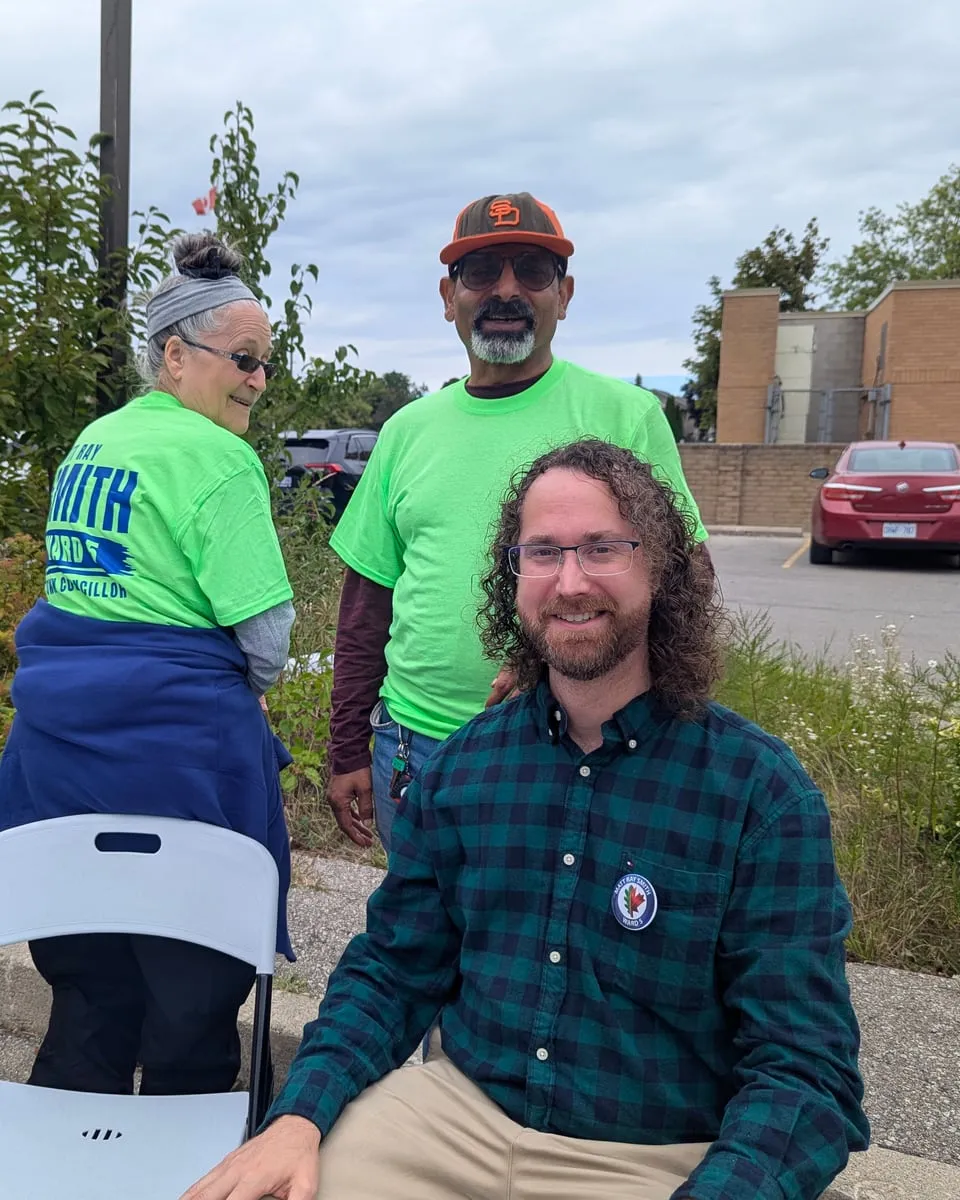 Matt smiling with campaign volunteers at a community barbecue