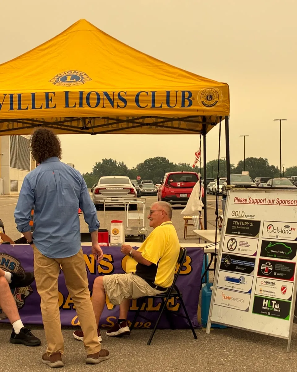 Matt talking with members of the Oakville Lions Club at their tent